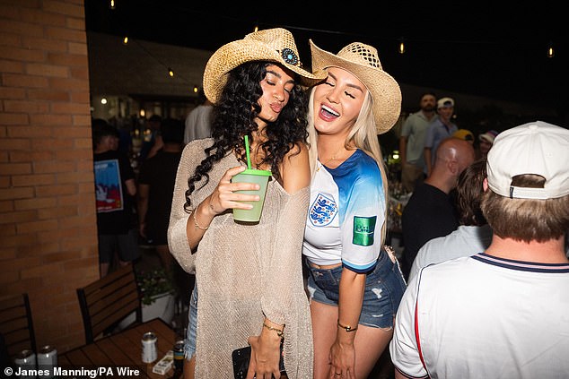Drinking Dallas dry! England fans are kicked out of a bar by police as they down $4 pints, strip off – and take over the rodeo – hours before World Cup opener against Croatia