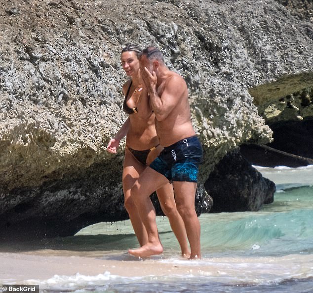 Ryan Giggs, 52, soaks in the Caribbean sunshine with lingerie model girlfriend – 14 years his junior – while his Class of 92 teammates live it up in New York for the World Cup