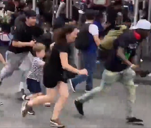 Tourists run for their lives as gunfire erupts in New York’s Times Square as terrified parents drag children to safety
