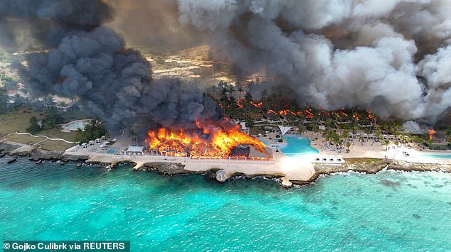 At least one dead and 1,700 evacuated in horror fire at luxury beach resort on Caribbean island