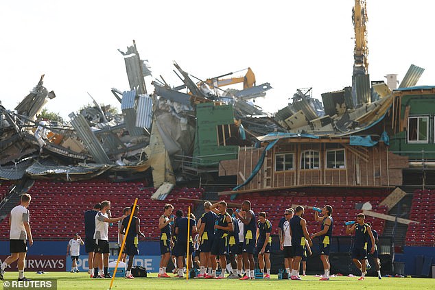 Demolition ‘goes wrong’ at stadium hosting World Cup team – forcing stunned players to practice in front of a mangled stand