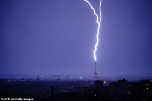 Moment lightning strikes Eiffel Tower as thunderstorms hit France following heatwave