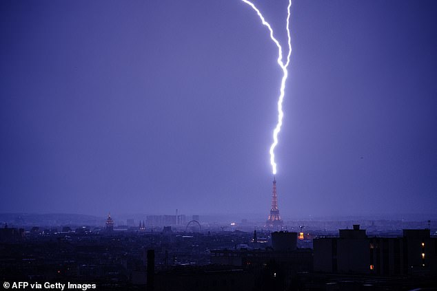 Moment lightning strikes Eiffel Tower as thunderstorms hit France following heatwave