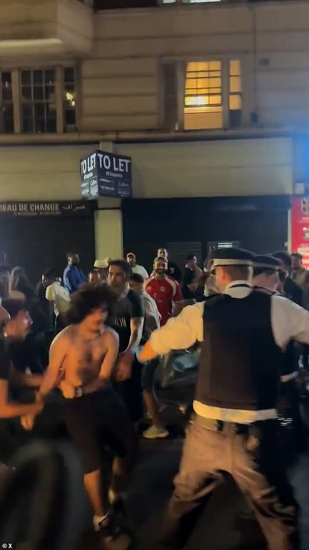 Egyptian fans bring chaos to London as they battle with police and climb on double decker bus to celebrate team’s World Cup win