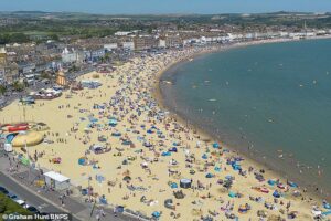 You wait ages for a heatwave, then three turn up at once! UK set to sizzle for THIRD time this summer, with temperatures expected to top out at 34C next week