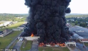 Massive fire breaks out at warehouse sending unbelievably thick clouds of black smoke billowing into the sky