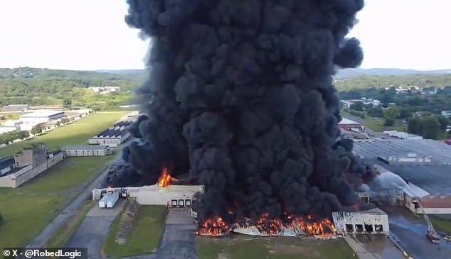Massive fire breaks out at warehouse sending unbelievably thick clouds of black smoke billowing into the sky