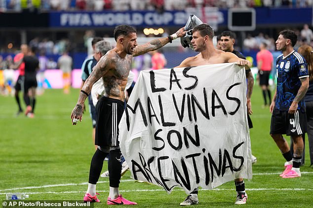 Argentina players hold banner claiming the Falkland Islands after knocking England out of the World Cup