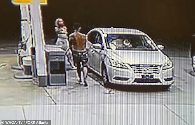 Heart-stopping moment mother uses GAS PUMP to defend her child from stranger intent on abducting him from gas station in dead of night