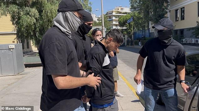 Afghan migrant accused of killing British charity worker then hiding her in a suitcase is seen heading to Greek court